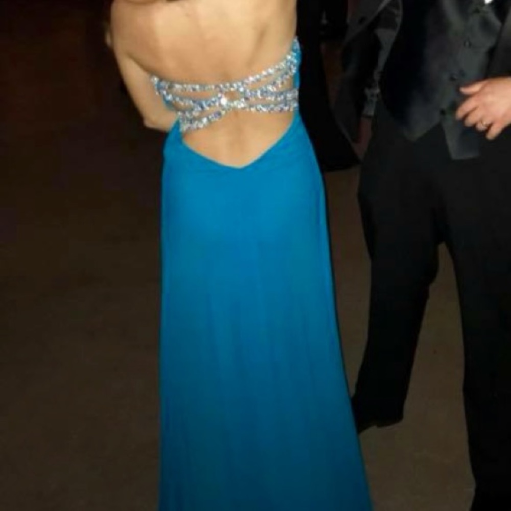 Blue long dress. Open back with sparkly straps.